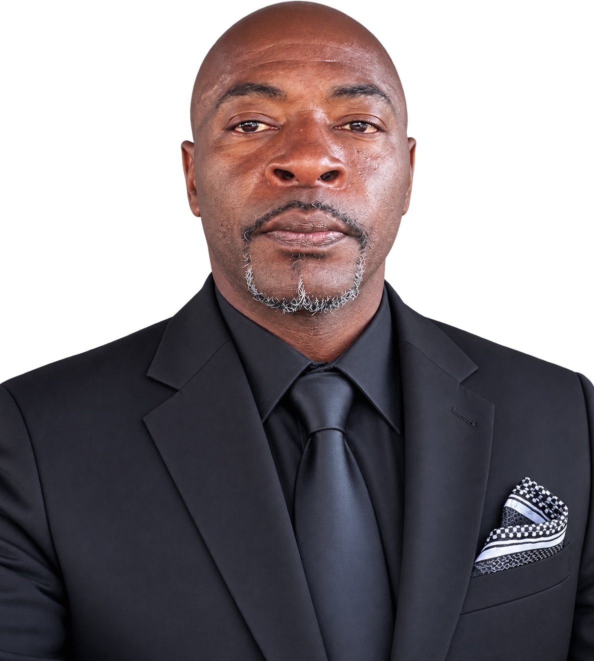 Richard Caradine wearing a black suit and tie